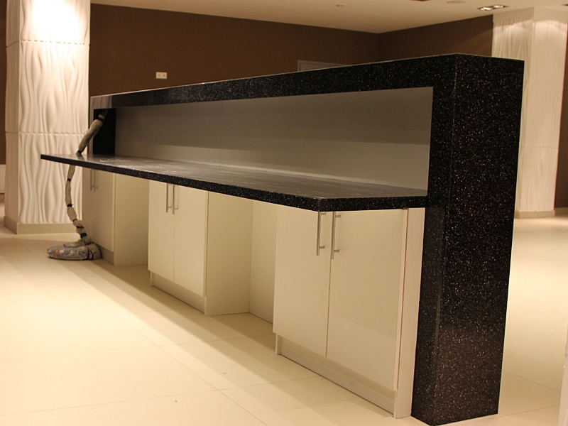 Тёмные стойки ресепшн из искусственного камня